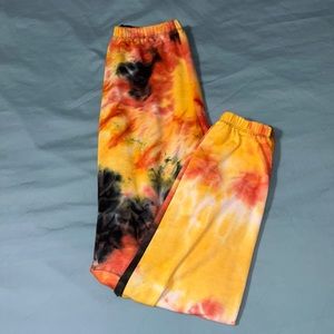 Orange, yellow, black, and white tie die joggers